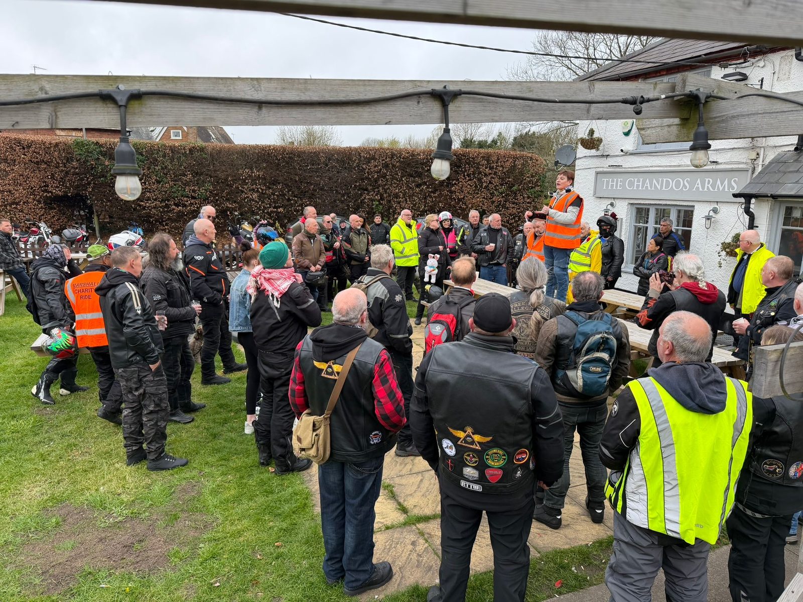 A large group of people gathered together at the pub for a celebration